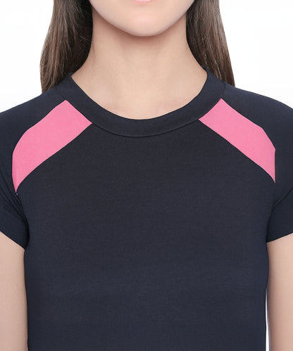 The Sportswear Navy Blue Tracksuit features a short-sleeve top with pink shoulder accents, ideal for workouts or lounging at home. Shown from shoulders to chest.