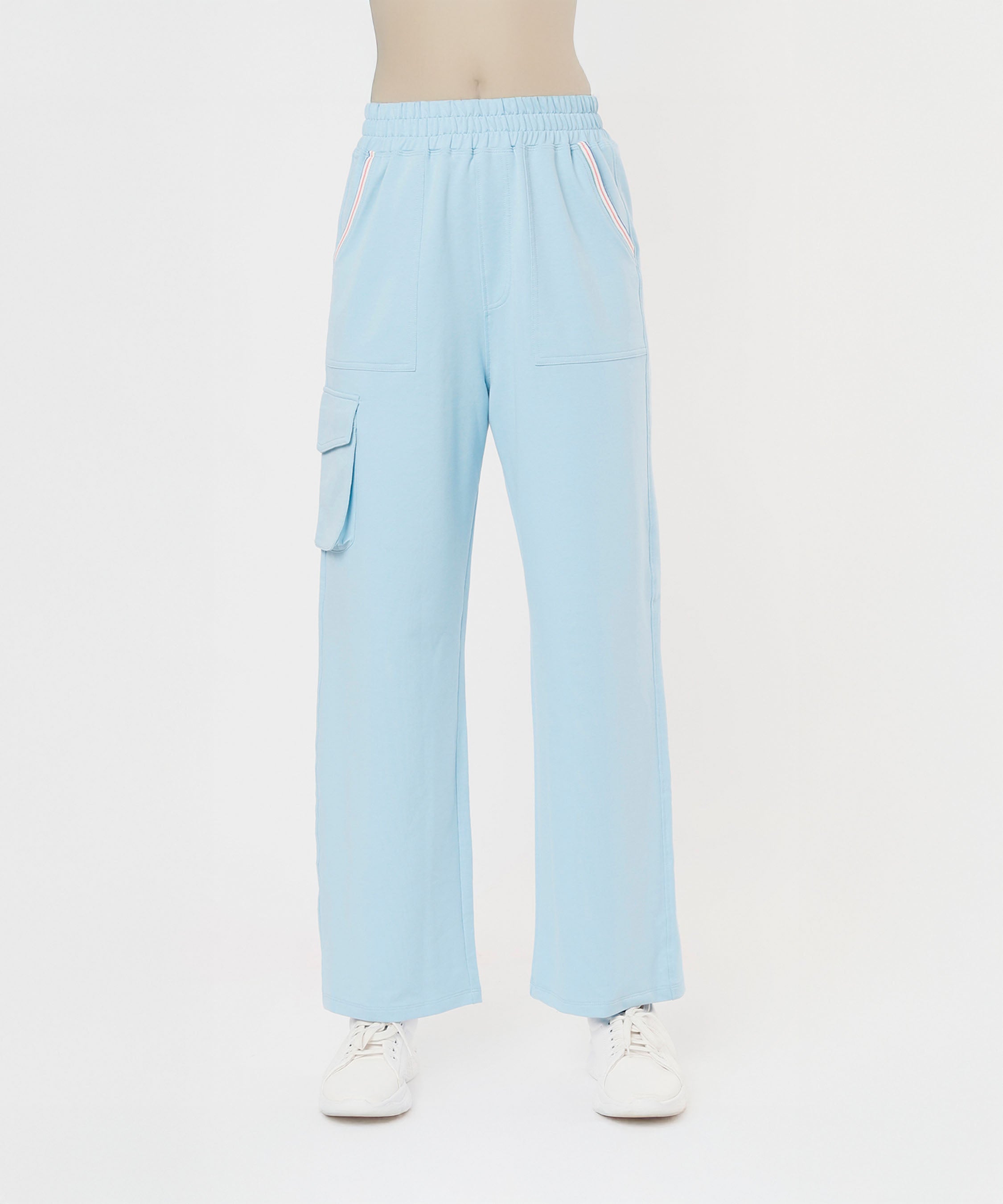 Person wearing the Blossom Blue Set with Crop Top, featuring light blue wide-leg pants with side pockets and white sneakers on a white background.