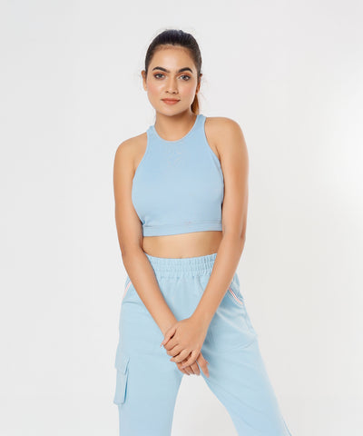 A woman poses gracefully against a plain white background wearing the Blue Dream Crop Top.