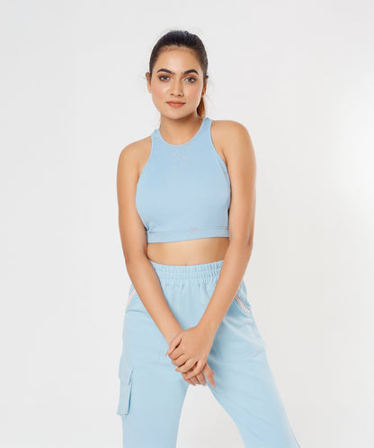 A woman poses gracefully against a plain white background wearing the Blue Dream Crop Top.