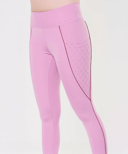 Model wears Tuna Active Pink Lilac Leggings featuring a laser cut pocket and black seam detail, shown from the waist down.