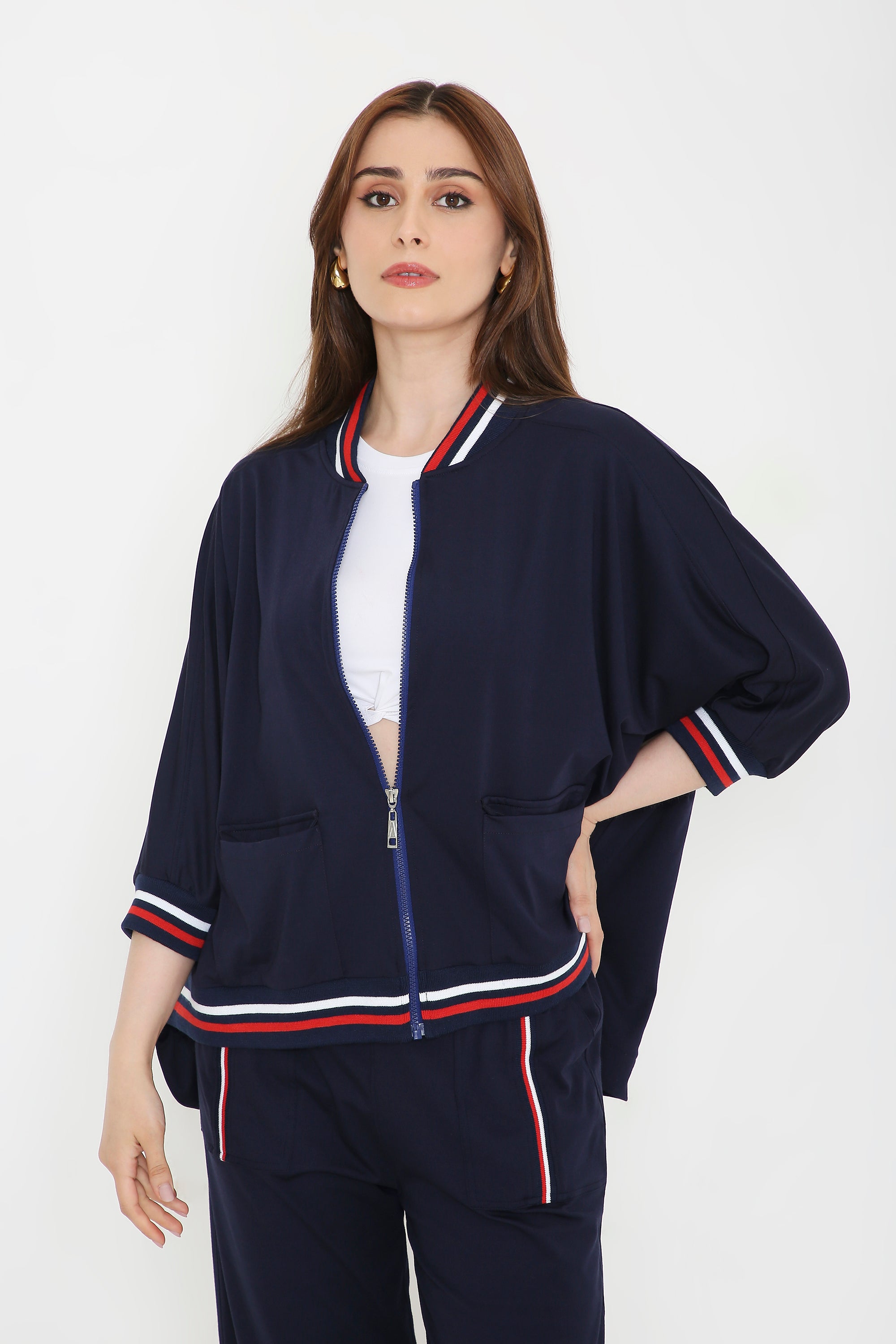 Woman wearing the Navy Blue Zipped Long Jacket with Tracks, featuring red, white, and blue trim—an ideal choice for stylish women’s activewear.
