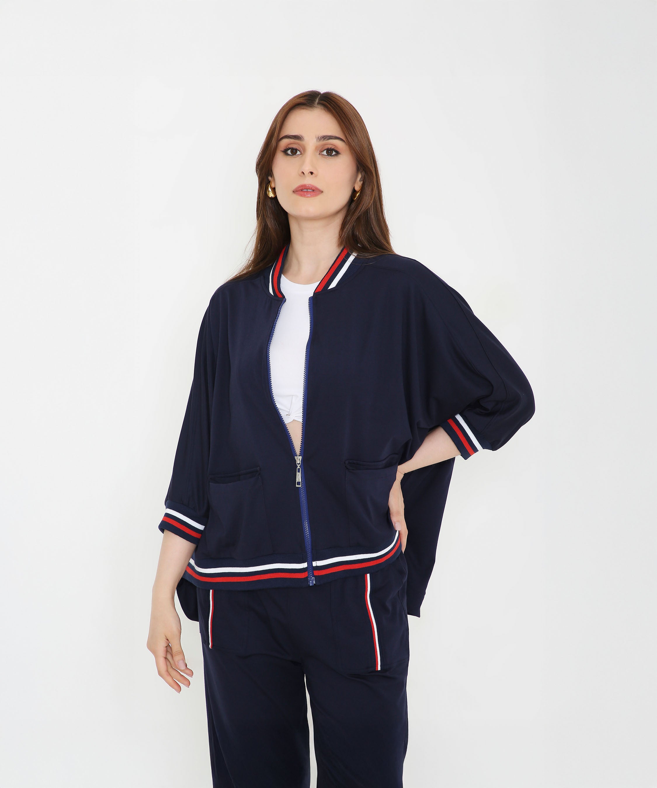 Woman wearing the Navy Blue Zipped Long Jacket with Tracks, featuring red, white, and blue trim—an ideal choice for stylish women’s activewear.