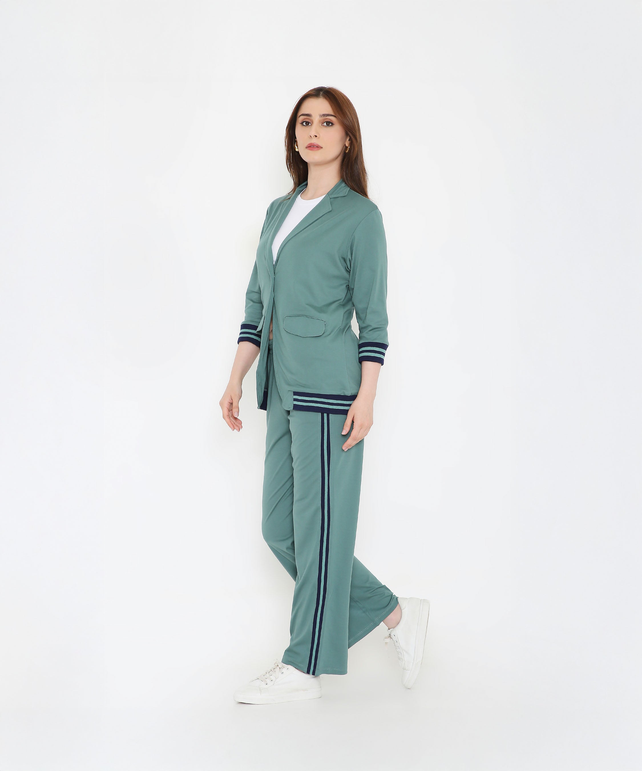 Woman wearing the Sage Green Athleisure Blazer Jacket and Track Set, paired with a white shirt and sneakers, standing against a white background.