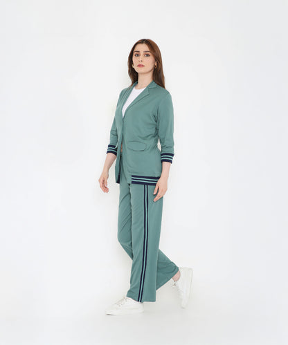 Woman wearing the Sage Green Athleisure Blazer Jacket and Track Set, paired with a white shirt and sneakers, standing against a white background.