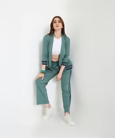 Woman wearing the Sage Green Athleisure Blazer Jacket and Track Set with a white crop top and sneakers, posing against a plain white background.