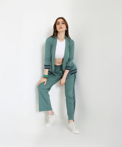 Woman wearing the Sage Green Athleisure Blazer Jacket and Track Set with a white crop top and sneakers, posing against a plain white background.