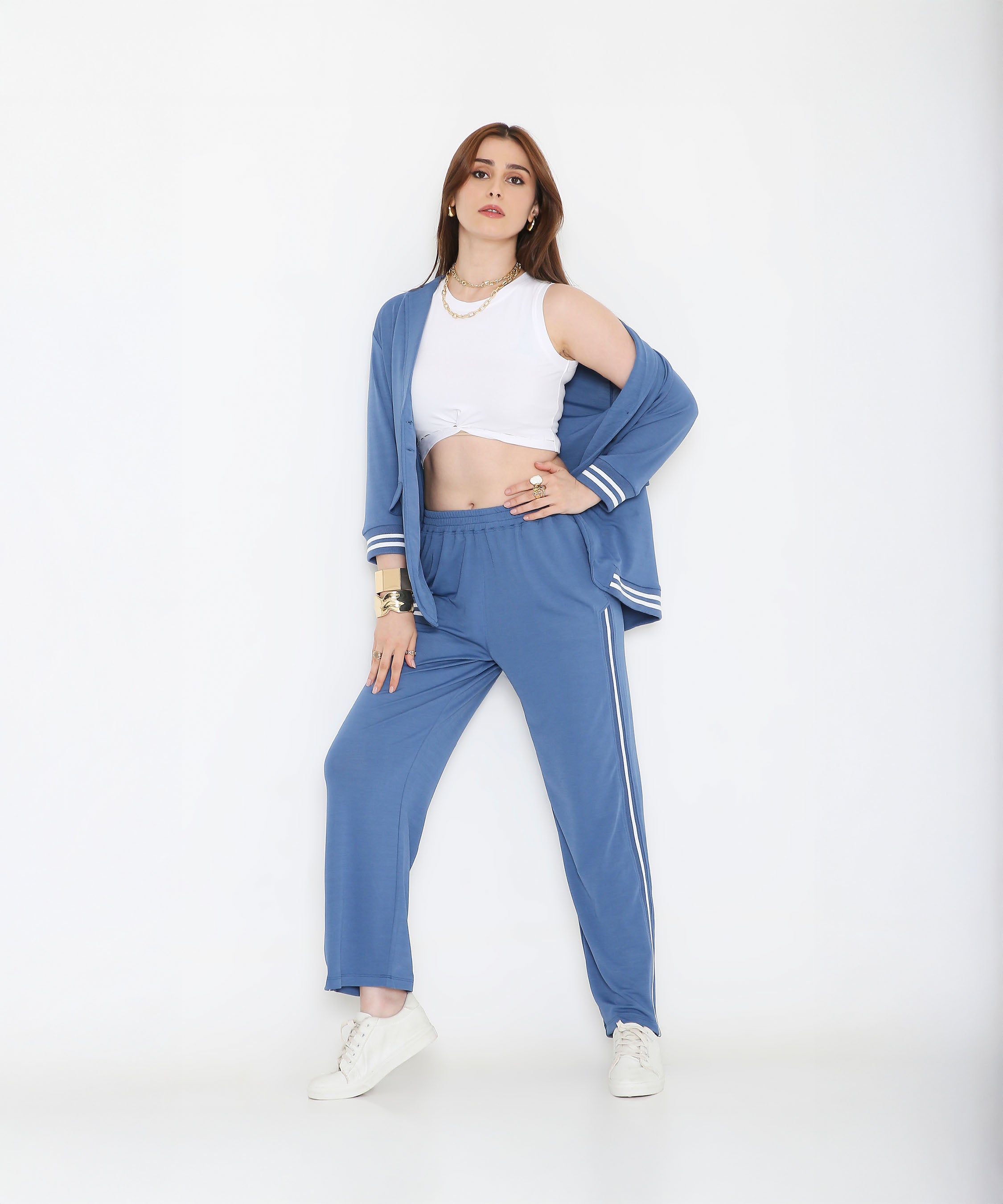 Woman wearing the Atlantic Blue Athleisure Blazer Jacket and Track Set with a white crop top and sneakers, posing against a white background.