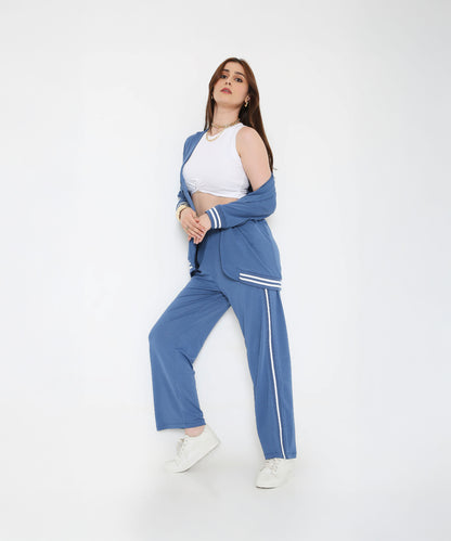 Woman posing in the Atlantic Blue Athleisure Blazer Jacket and Track Set with a white crop top and white sneakers against a plain white background.