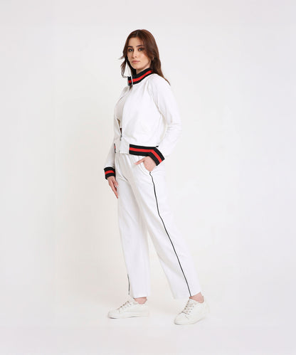 Model wearing the Two Piece Bold Contrast White Tracksuit in soft cotton-blend fabric with black and red trim, posing against a white background for a sporty-chic look.