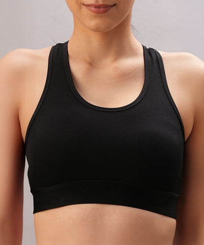 Model wears the Black Sports Bra with adjustable straps, shown from shoulders to waist against a neutral background.