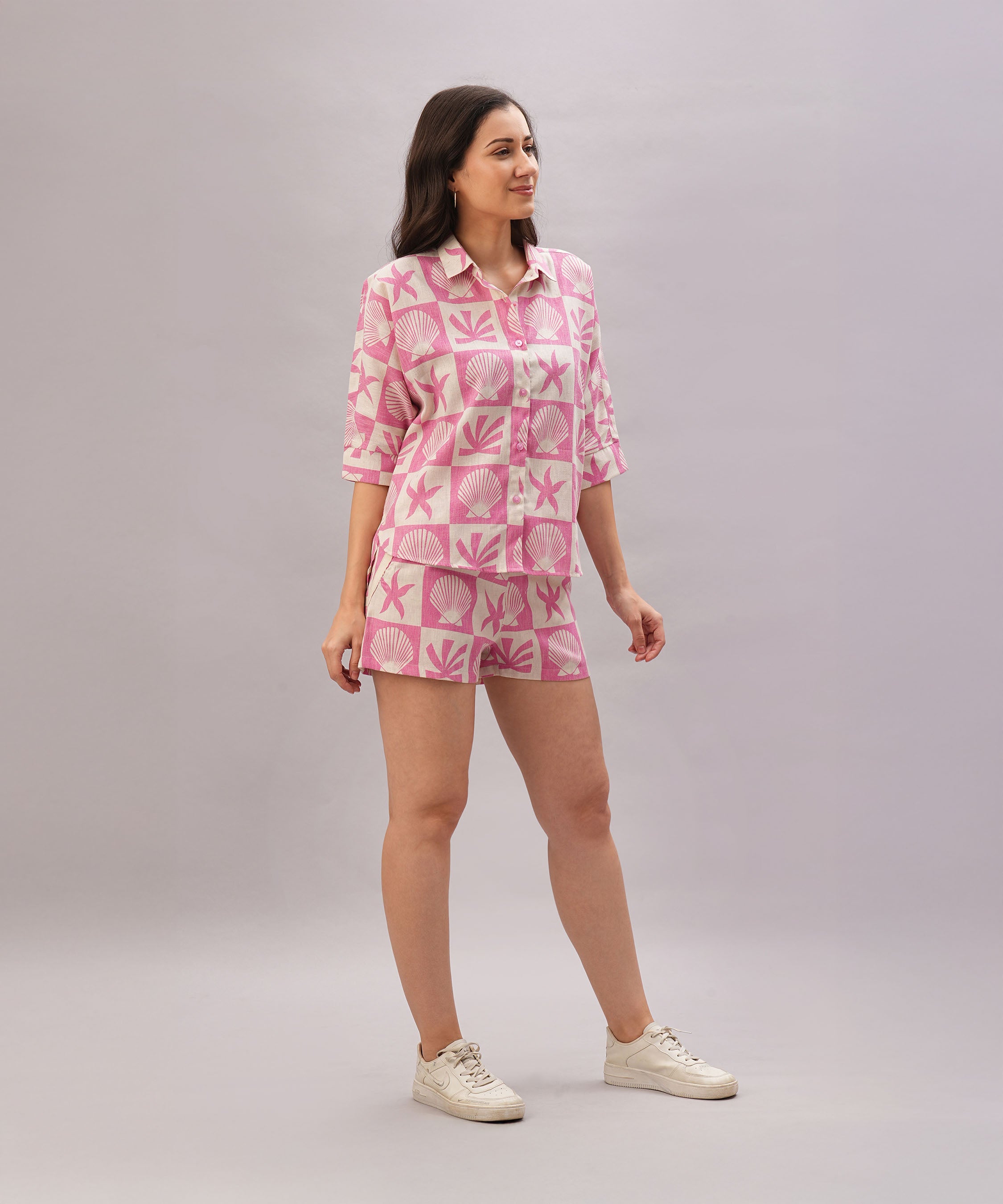 Woman wearing the Pink Co-Ord set, a stylish ensemble with a trendy top and matching bottoms, smiles against a neutral background.
