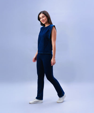 Woman wearing the Blue Denim Wash Capsleeves Tops and Bootcut Leggings Set, standing and smiling against a light blue background.