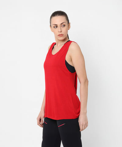 Woman wearing a Red Tank Top With Overlap Back and black pants, standing against a plain white background.