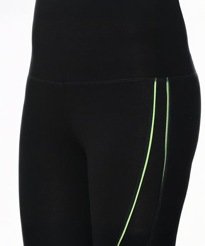 Model showcases Fab Fit Neon Pop Leggings in black with neon green side stripes and a high-rise waistband, visible from waist to mid-thigh against a white background.
