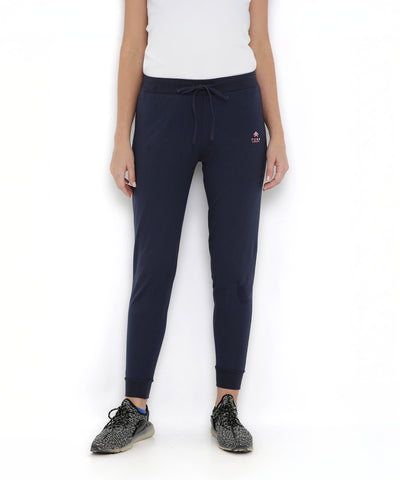 Person wearing a white top, Blue Classic Joggers TLC04, and black sneakers stands against a white background.