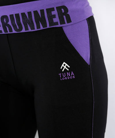 Close-up of black and purple Regular Fit Trackpants TLC05 with a branded waistband featuring "RUNNER" and "TUNA LONDON" details.