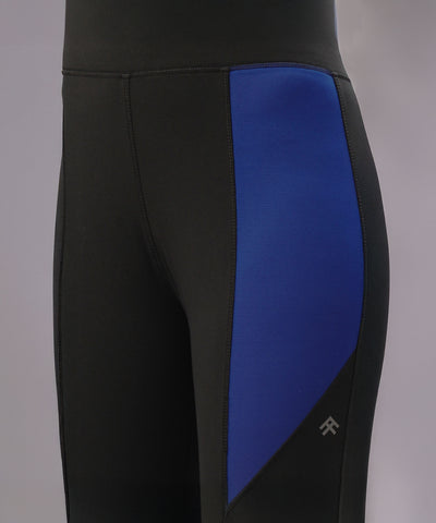 Close-up of Black and Blue Pants, made from four-way stretch fabric with a blue side panel and visible stitching for a high-performance fit.
