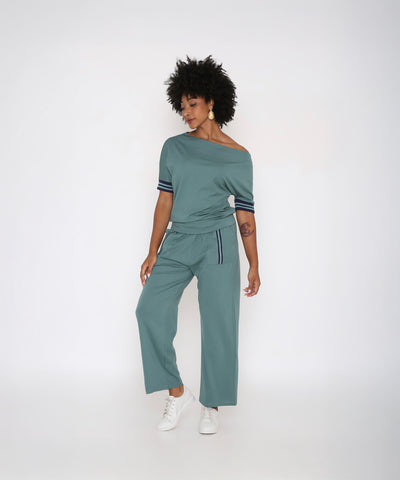 A woman in a Sporty Sage Green Off-shoulder Tracksuit Set.