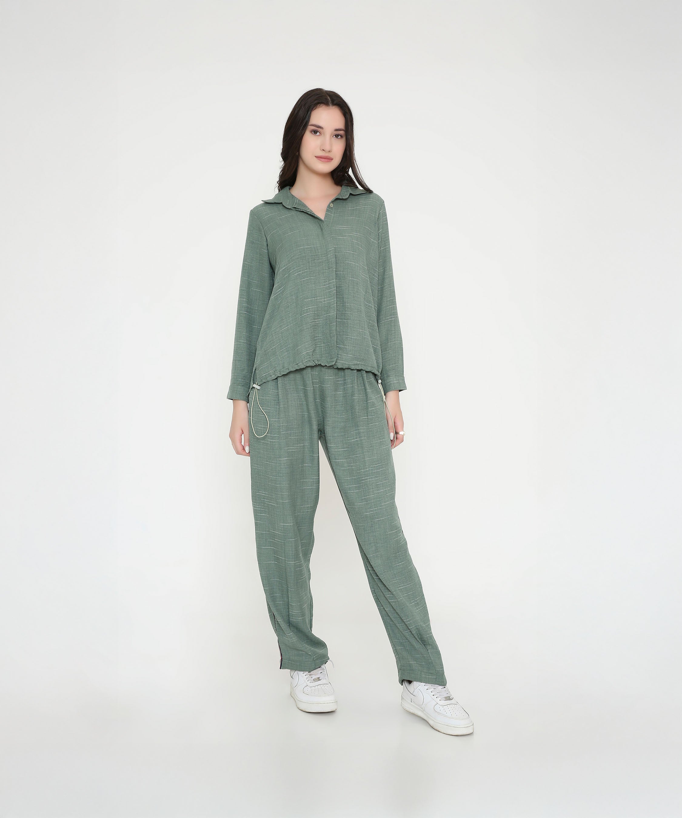 Woman wearing the Moss Green Breezy Cord Set in a relaxed fit with white sneakers, standing against a plain white background.