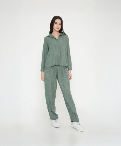 Woman wearing the Moss Green Breezy Cord Set in a relaxed fit with white sneakers, standing against a plain white background.