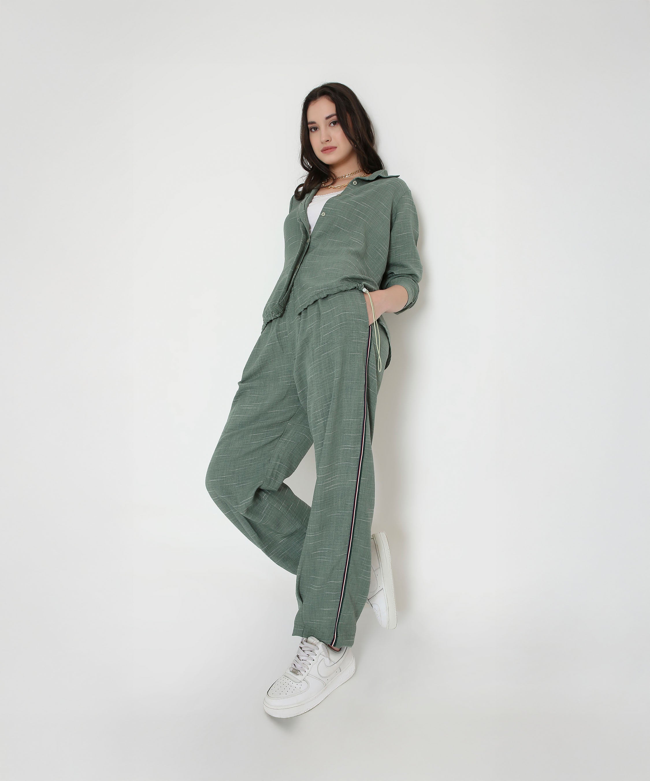 Model wears the Moss Green Breezy Cord Set with white sneakers, standing against a plain white background.