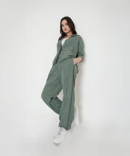 Model wears the Moss Green Breezy Cord Set with white sneakers, standing against a plain white background.
