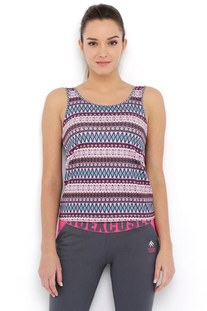Woman wearing the Multi-Print Sleeveless Tee With Built-In Bra Cups BT70 and dark gray athletic pants, perfect for heavy workouts, standing against a white background.
