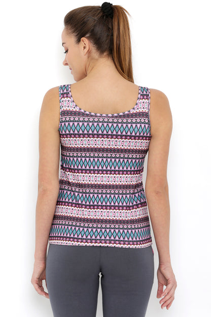Woman with long hair in a ponytail, seen from the back, wears the Multi-Print Sleeveless Tee With Built-In Bra Cups BT70 and gray pants.