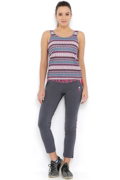 Woman wearing the Multi-Print Sleeveless Tee With Built-In Bra Cups BT70 and gray pants stands facing forward against a white background, perfect for intense workouts.