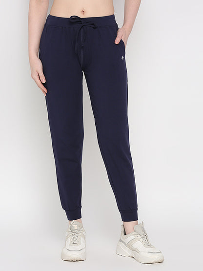 Model wearing Blue Classic Joggers TLC04 featuring an adjustable fit and white sneakers, standing against a light background—ideal for stylish loungewear.