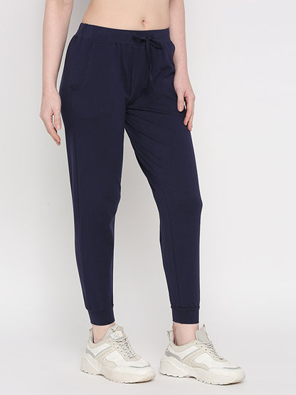 Model wearing Blue Classic Joggers TLC04 with an adjustable fit and white sneakers, standing against a plain background—ideal for casual loungewear.