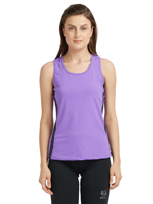 A woman stands against a white background wearing a Purple round neck sleeveless top with moisture-wicking properties and black leggings.